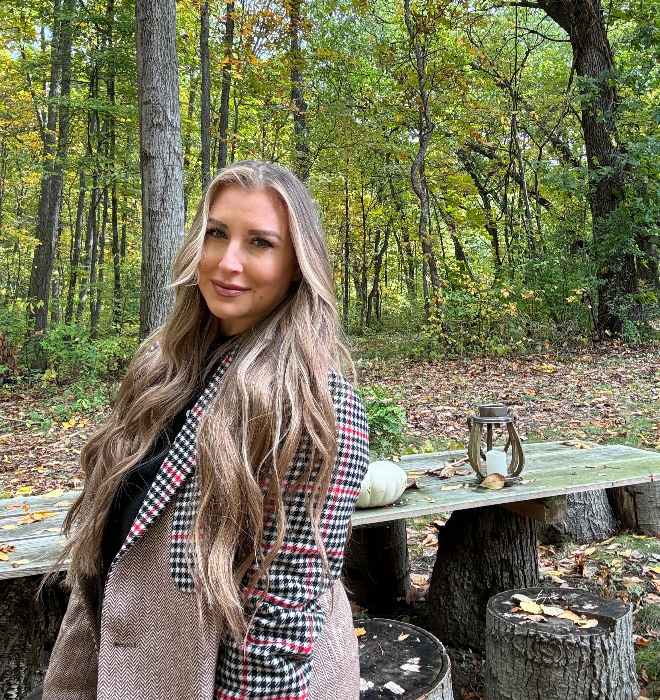 Quinn in plaid blazer in woods